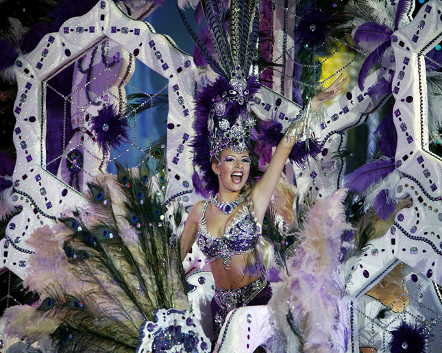 A nomine for Queen of the Santa Cruz carnival shows off her outfit under the watchful eyes of the jury at Santa Cruz de Tenerife on the Spanish Canary island of Tenerife, February 15, 2012. AFP PHOTO/DESIREE MARTIN